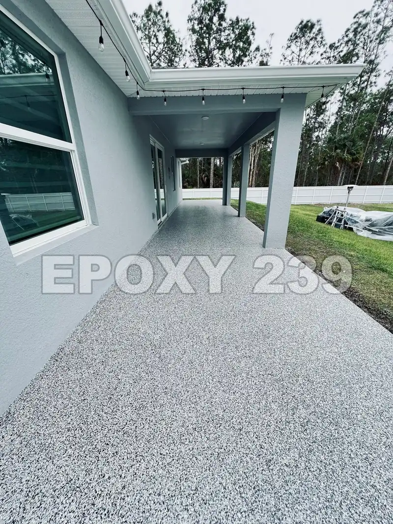 Long lanai beside a grey house, coated in Domino flake epoxy