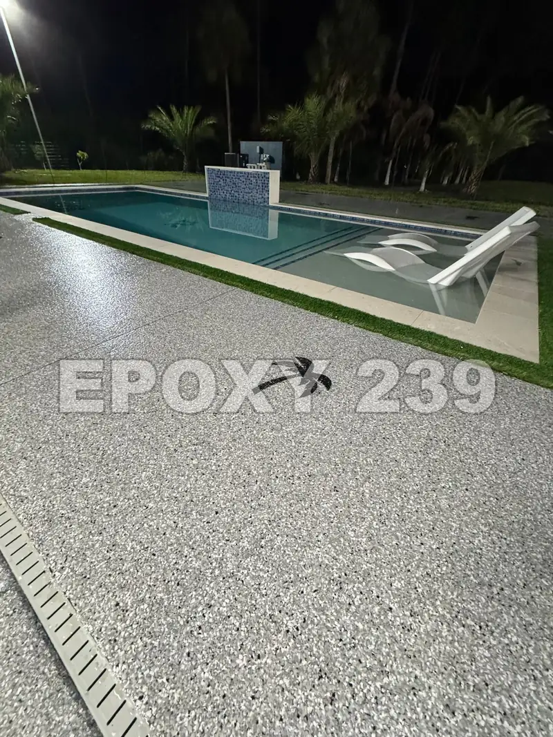 Pool deck at night coated in Feather Gray flake epoxy