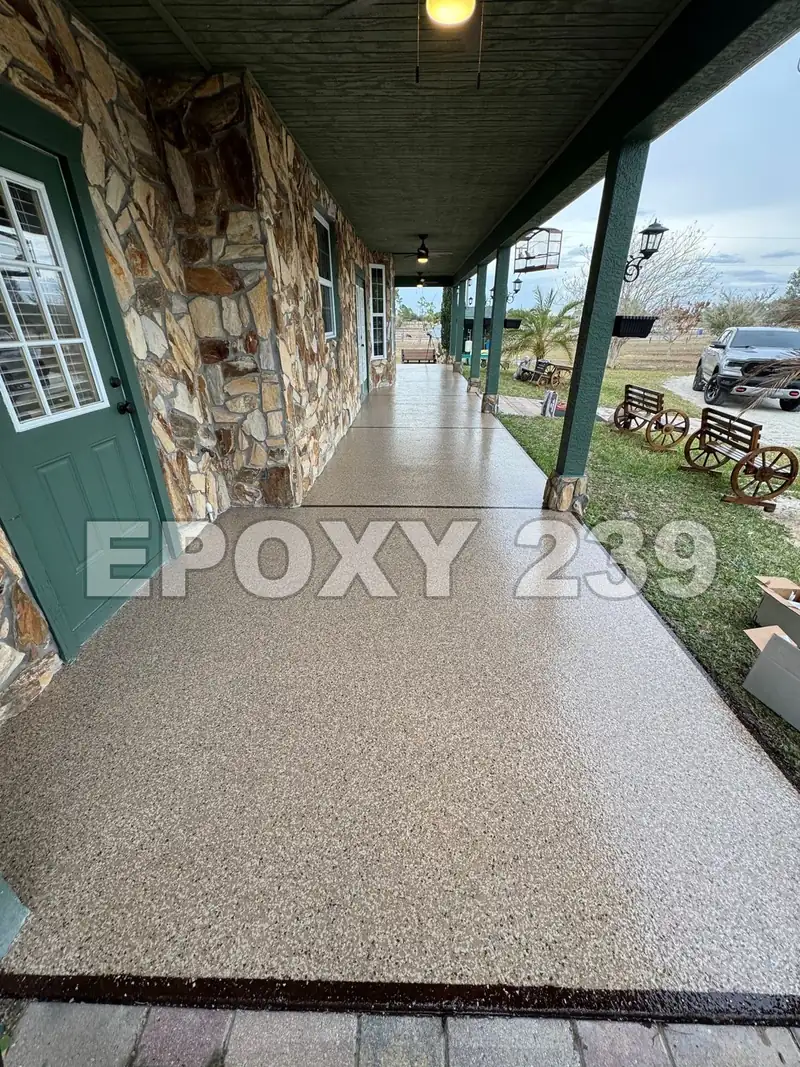 Long front porch with a stone wall, coated in Shoreline flake epoxy